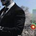 regresa-el-aire-sucio-a-nuevo-leon - Minuto Cero Man in a black suit speaks at a podium with a microphone, rubble behind him; an overlay shows a city view with a red thumbs-down badge indicating disapproval.